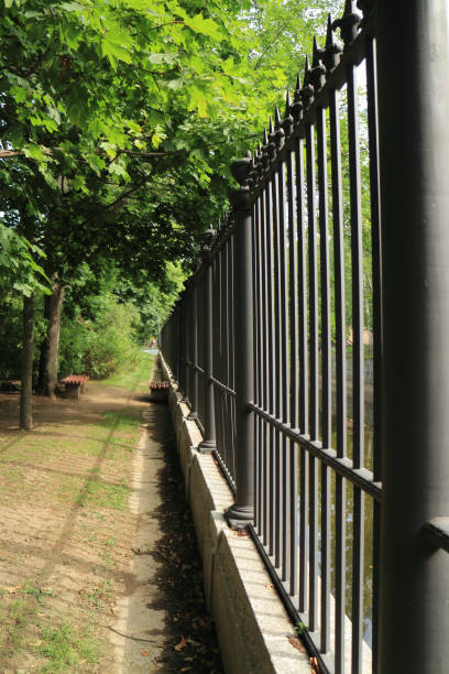 istock high steel fence out into the distance 1180846708