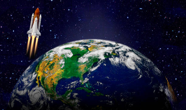 istock Space shuttle orbiting Earth planet. Elements of this image furnished by NASA 1180849986