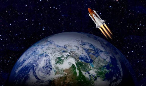 istock Space shuttle orbiting Earth planet. Elements of this image furnished by NASA 1180849997