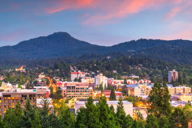 Eugene, Oregon, USA downtown Eugene, Oregon, USA downtown cityscape and mountains at dusk. eugene oregon stock pictures, royalty-free photos & images