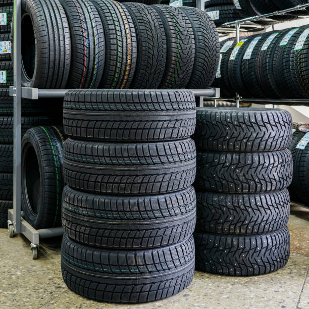 istock new winter tire sets with studs and without studs at tire shop 1180850611