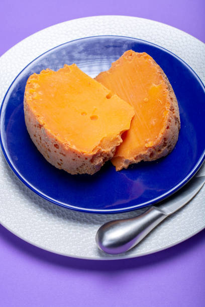 Two pieces of native French aged cheese Mimolette, produced in Lille with greyish curst made by special cheese mites
