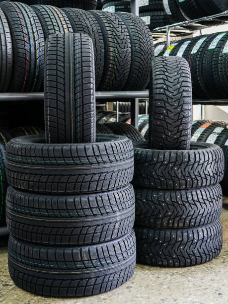 istock new winter tire sets with studs and without studs at tire shop 1180850771