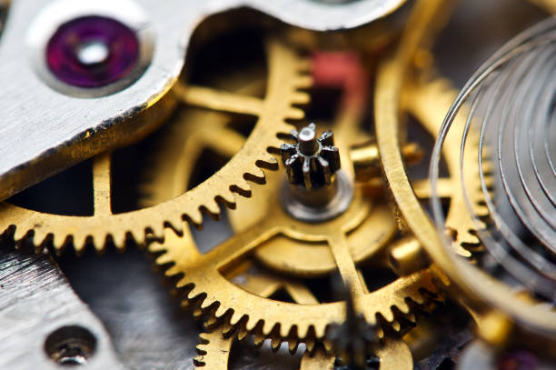 istock Cog wheels. Yellow gears, clockwork. The concept of time, teamwork, success 1180857993