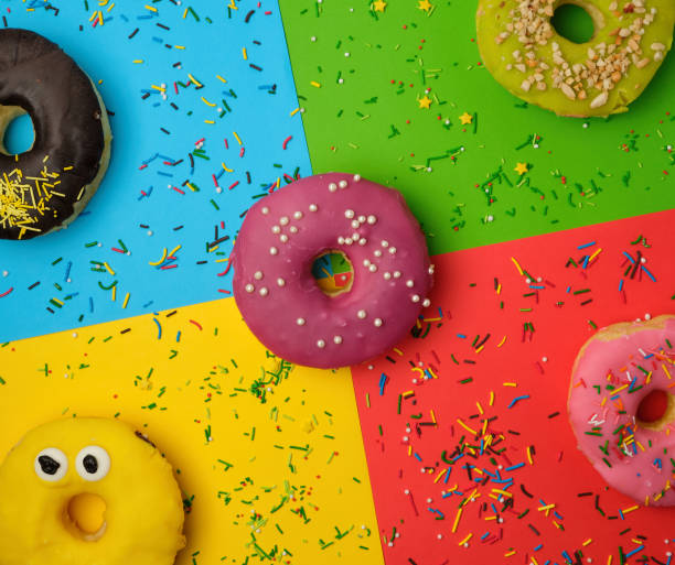 istock round donuts with various fillings and sprinkles on an abstract color background 1180858031