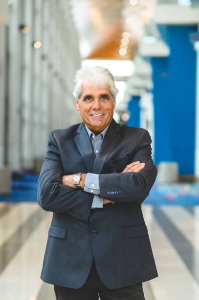 istock Corporate looking businessman in a suit office environment 1180858449