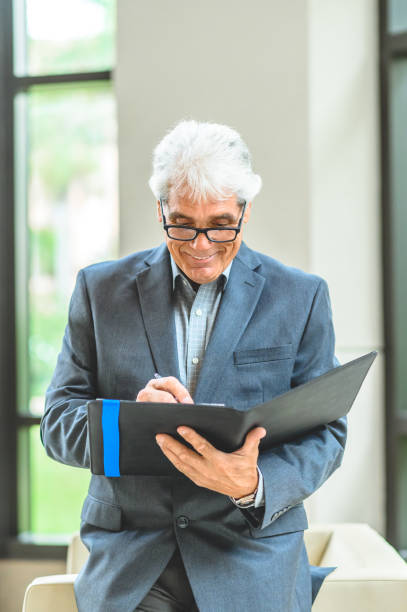 istock Corporate looking businessman in a suit office environment 1180859194