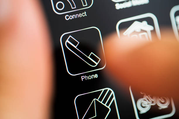 White app logo on black screen. Hand touching phone call app on dark mode phone screen.