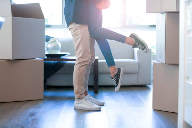 istock Couple embracing after moving into a new house. 1180860344