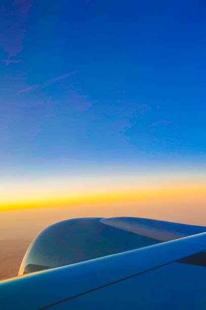 a view from inside commercial plane passenger cabin window on sunset view in the mid air - cloud mid air cloudscape aerial view imagens e fotografias de stock