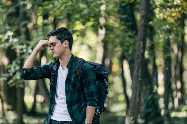 Male hiker has a headache
