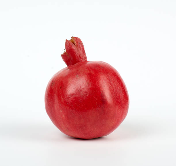 istock ripe red pomegranates in a peel on a white background 1180864348