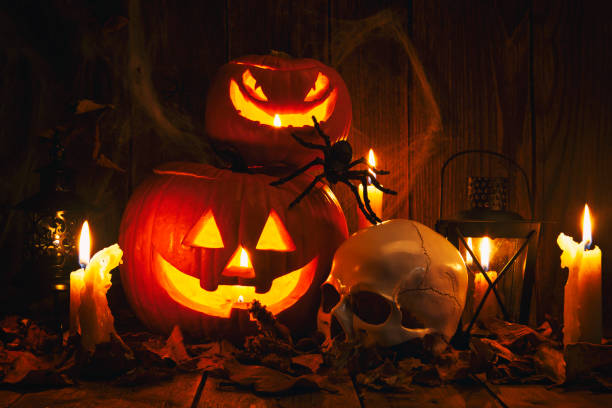 istock Halloween Jack-o-Lantern Pumpkins on rustic wooden background 1180869074