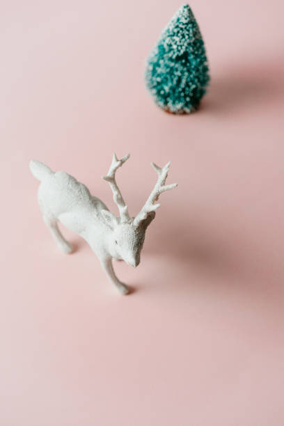 istock reindeer toy and pine tree, holiday composition 1180875166