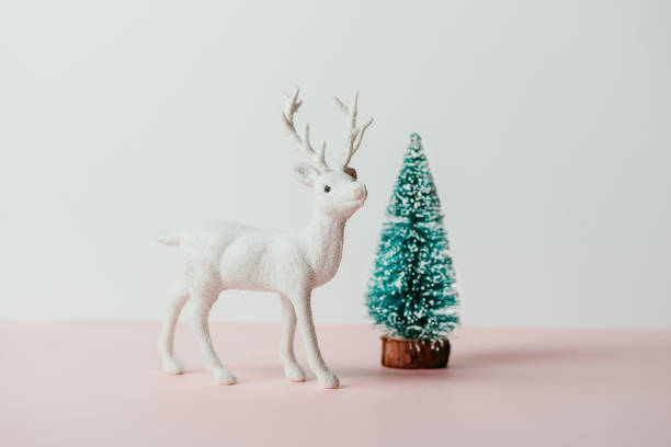 istock reindeer toy and pine tree, holiday composition 1180875192