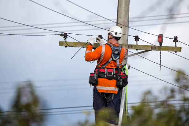 A linesman with a power company connects a new house in a rural area to the main network in New Zealand Sheffield, Canterbury, New Zealand, September 10 2019:An electrical worker from a power supply company works high up on the power lines to connect a new house to the network power line photos stock pictures, royalty-free photos & images