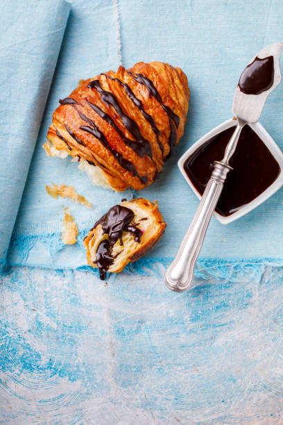 istock Breakfast Continental  with Fresh  Croissants with Chocolate and sauce on a blue Background  Delicious Baking Top View Copy space for Text 1180876083