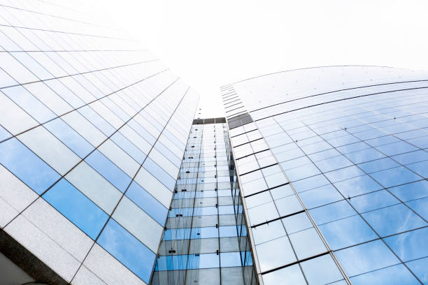 istock Low angle view of modern glass office building, skyscrapers, white background with copy space 1180878902