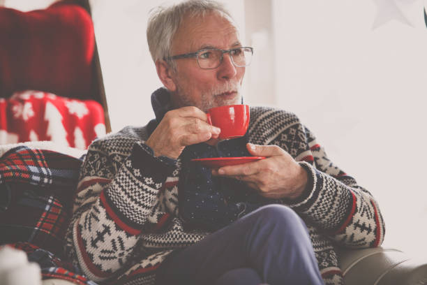 istock Senior man drinking tea at home 1180882470