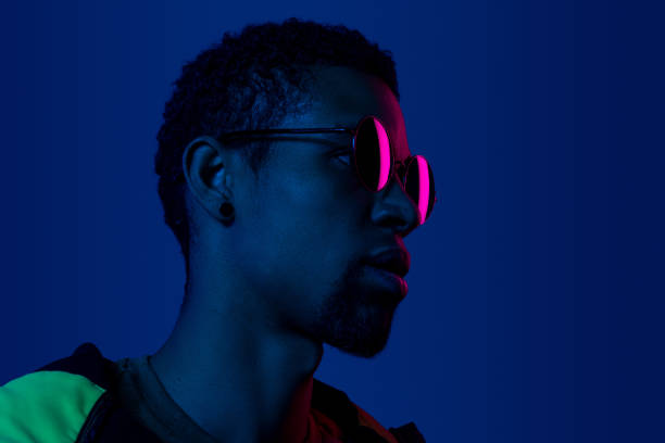 istock Dreamy black man in sunglasses looking away 1180883869