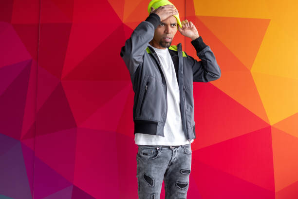 istock Thoughtful black male putting on hat 1180883895