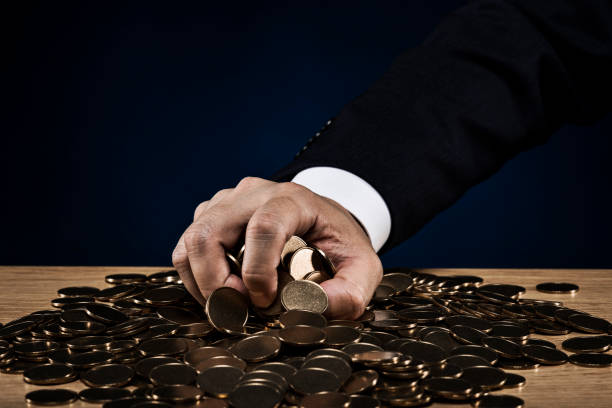istock Stacked coins and male hand 1180887718