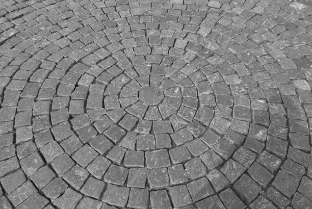 istock old gray pavement of cubic cobblestones laid in concentric circles 1180888765