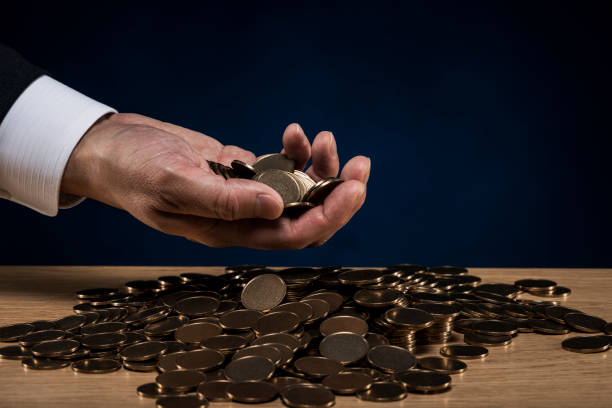 istock Stacked coins and male hand 1180888911
