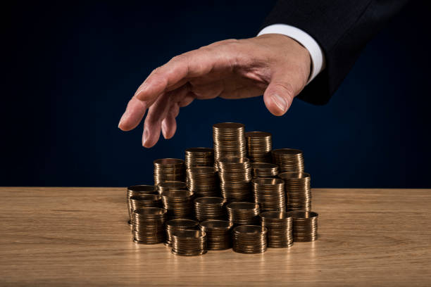 istock Stacked coins and male hand 1180888962