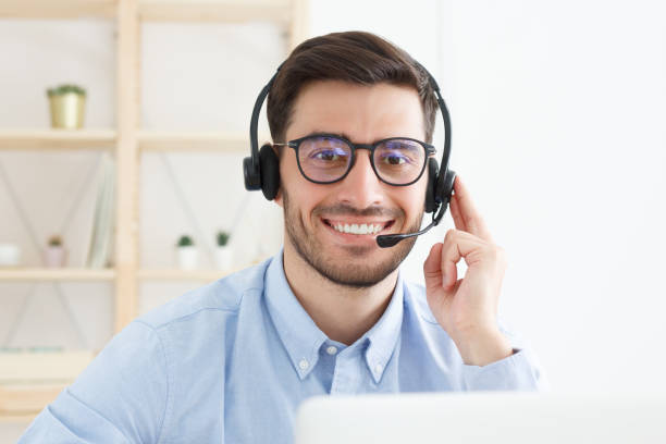 istock Customer service. Close-up portrait of young male technical support in call centre 1180889041