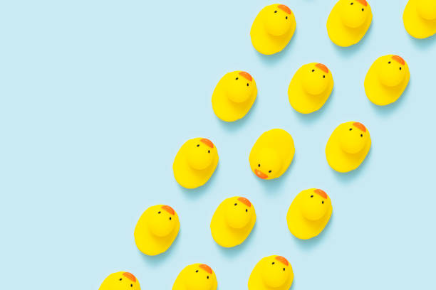 istock Yellow rubber duck flat lay on blue background. 1180889986