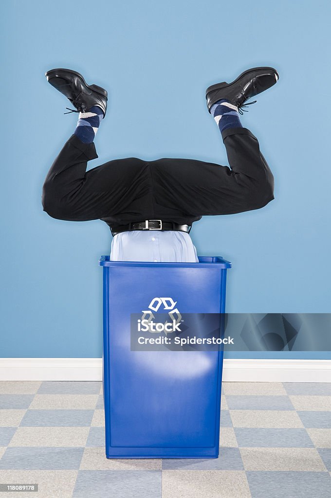 Corporate Executive Discarded in Recycling Container. Corporate executive discarded head first in recycling container. Adult Stock Photo