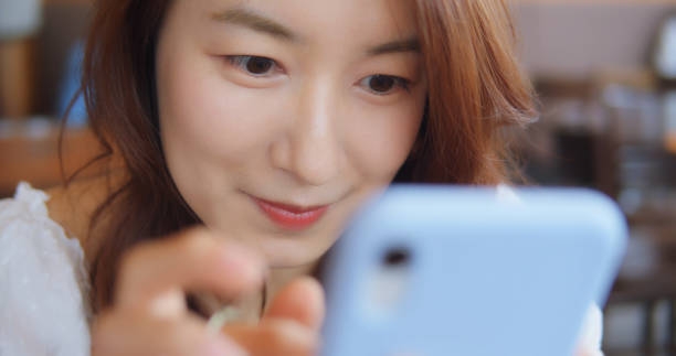 istock Woman Using Smart Phone At Coffee Shop 1180894471