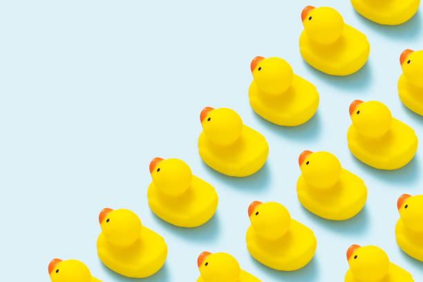 istock Yellow rubber duck flat lay on blue background. 1180894779