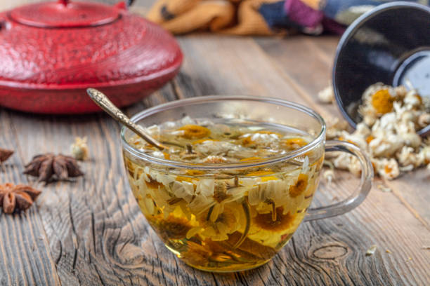 istock Cup of medicinal chamomile tea. Chamomile tea on the wooden table. 1180894948
