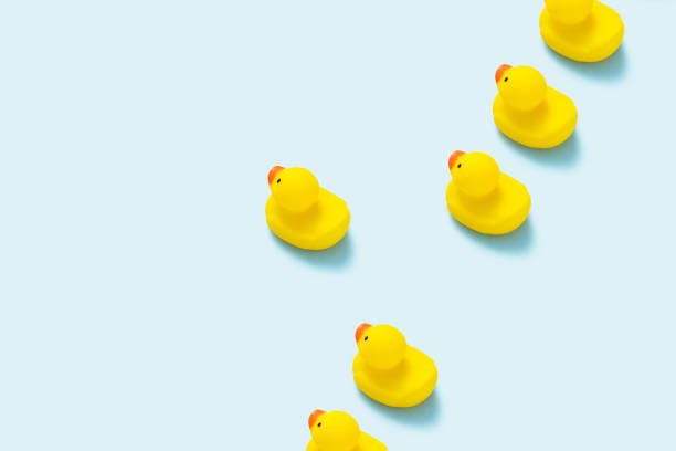 istock Yellow rubber duck flat lay on blue background. 1180895479