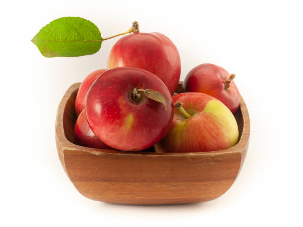 istock Fresh red apples in a acacia wood bowl 1180896547