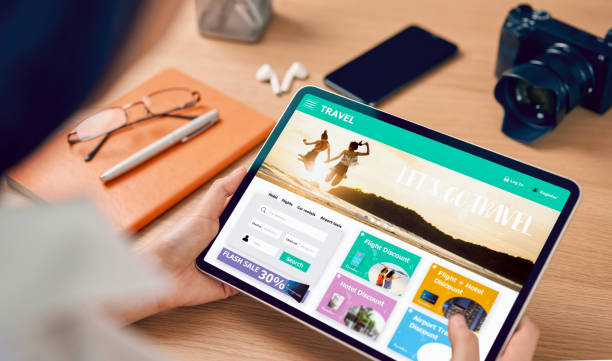 istock Hands holding digital tablet with application booking flight travel search ticket holiday and hotel on website discounted price, concept technology online marketing and promotion. 1180897642
