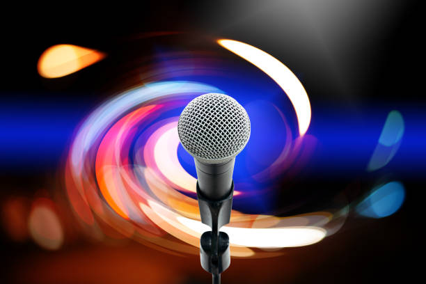 High fidelity microphone with light trail. Close up of high quality dynamic microphone on stand with colorful light bokeh in background.
High fidelity microphone with light trail. amplifier plug stock pictures, royalty-free photos & images
