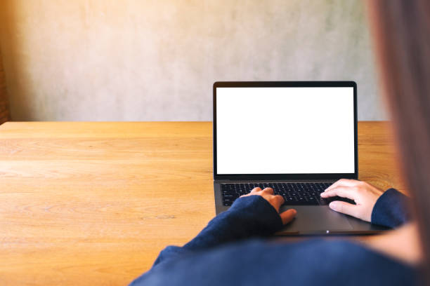 istock a hand using and touching on laptop touchpad with blank white desktop screen on wooden table 1180900331