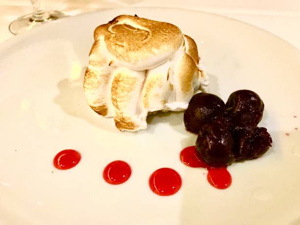 istock Baked Alaska with blueberries and cherries sauce 1180900443