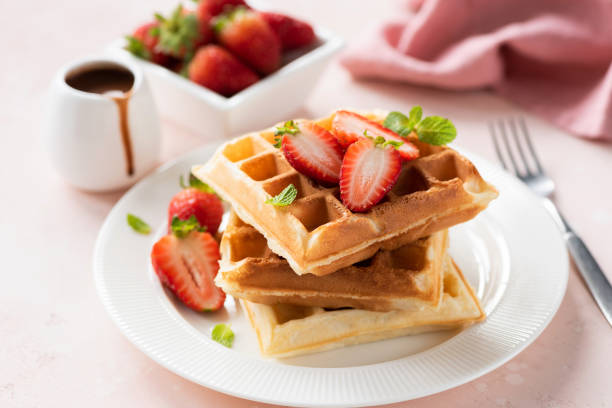 istock Tasty belgian waffles with strawberries 1180901250