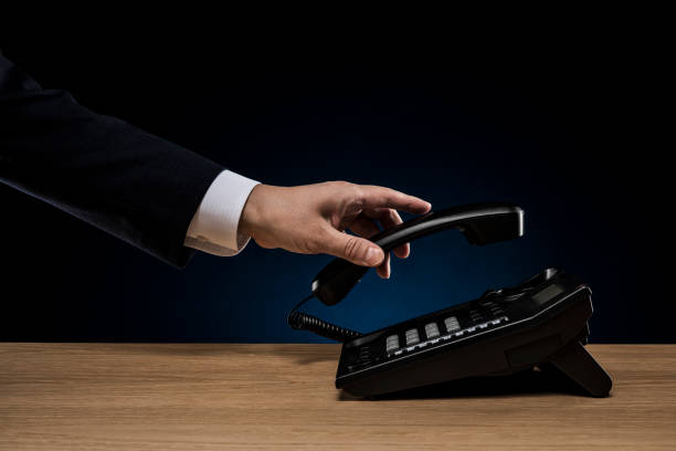 istock Businessman taking a telephone handset on the desk 1180902343