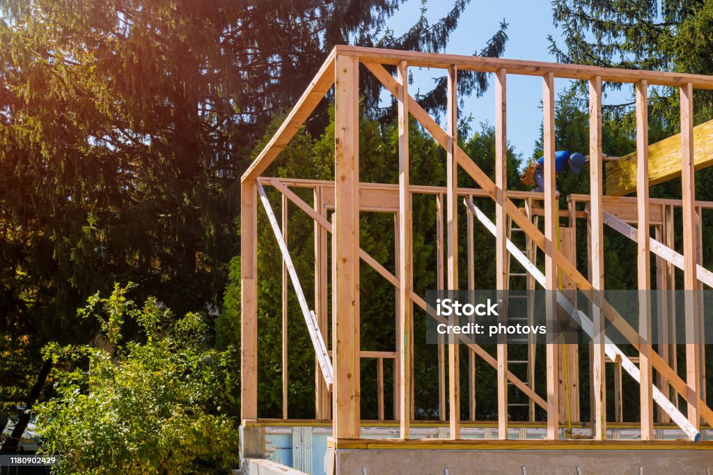 Beam stick built frame of a new house under construction Beam stick built frame of a new house under construction of the wooden house Home Addition Stock Photo