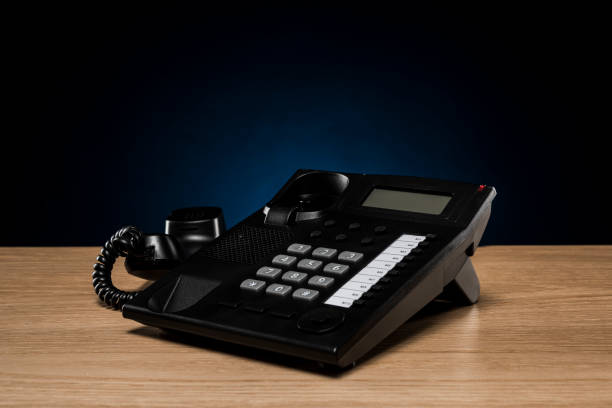 istock Businessman taking a telephone handset on the desk 1180903223