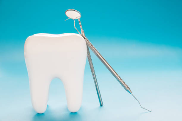 istock Close up big tooth and dentist tool. 1180903245