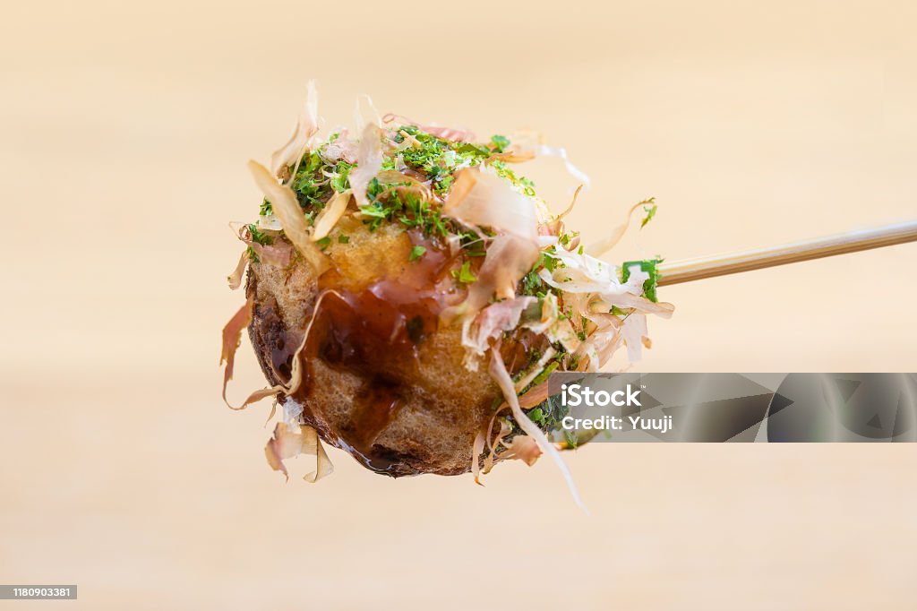 Octopus grill recipe.  Takoyaki close-up with skewers. There is bonito Octopus grill recipe.　The ingredients are octopus, flour, eggs, leeks, cabbage and red ginger. When finished, eat bonito, green seaweed, mayonnaise, and sauce. Takoyaki Stock Photo