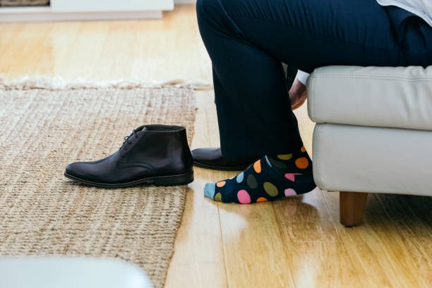 istock Groom Putting On Colourful Socks On Wedding Day 1180904382