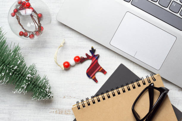 istock Merry Christmas and Happy new years office work space desktop concept. Flat lay top view with laptop, notebook and Christmas ornaments. 1180904394