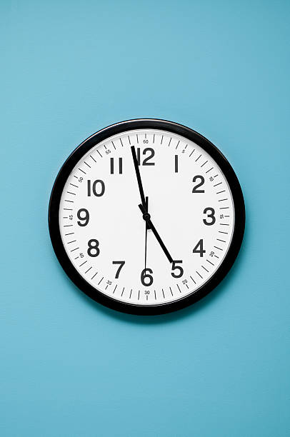 Wall Clock Wall clock showing 5PM quitting time. clock face photos stock pictures, royalty-free photos & images